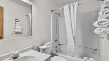 A bathroom with a sink, toilet, and bathtub.