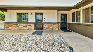 A modern building with a stone facade, a front door, and a small entryway.