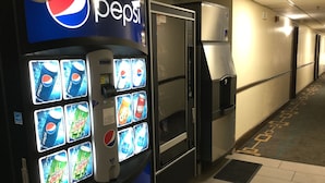 A vending machine with Pepsi and Mountain Dew options in a hallway. - Super 8 by Wyndham Clearwater/St. Petersburg Airport (Clearwater)