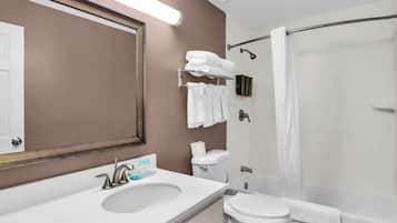 A bathroom with a sink, toilet, and shower.
