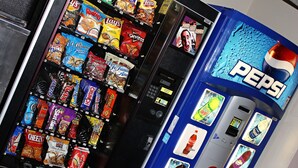 A vending machine with various snacks and a Pepsi dispenser. - Capri Inn and Suites of Beatrice (Beatrice)