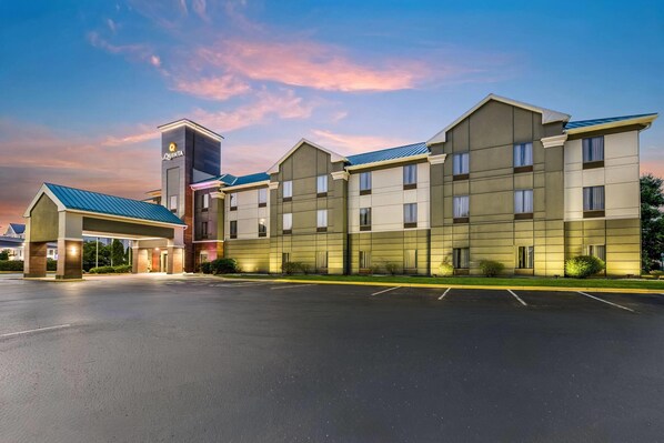 A multi-story hotel with a flat roof and a prominent sign on the corner. - La Quinta Inn & Suites by Wyndham Louisville East (Louisville)