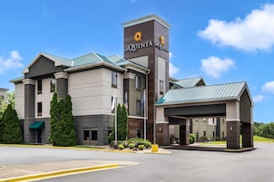 A hotel with a prominent 'La Quinta' sign, a covered entrance, and a parking lot.
