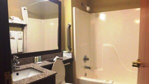 A bathroom with a sink, toilet, and bathtub.