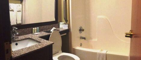 A bathroom with a sink, toilet, and bathtub.