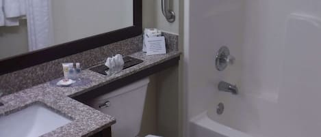 A bathroom with a sink, toilet, and shower.