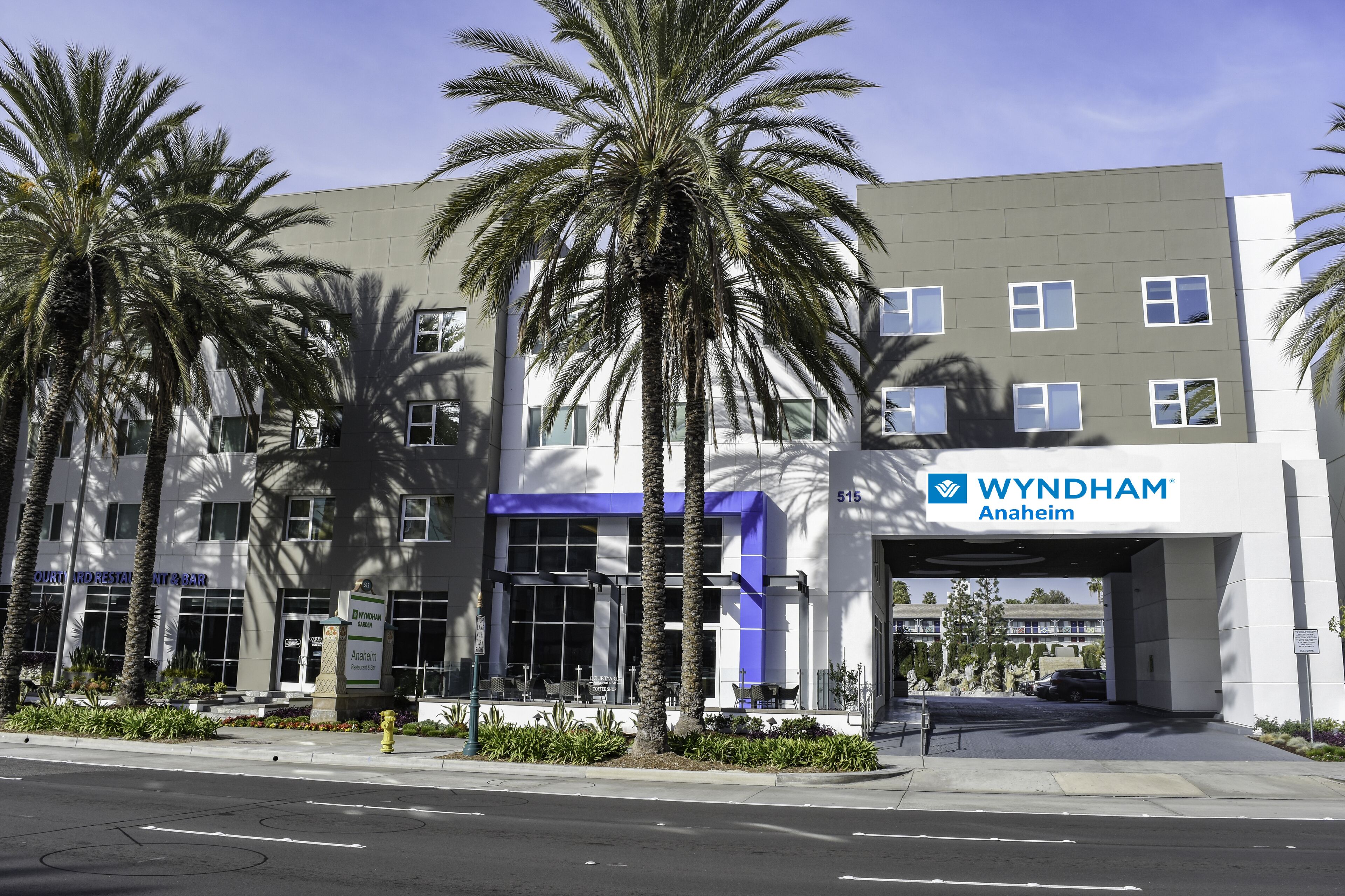 A modern building with a sign for Wyndham Anaheim.