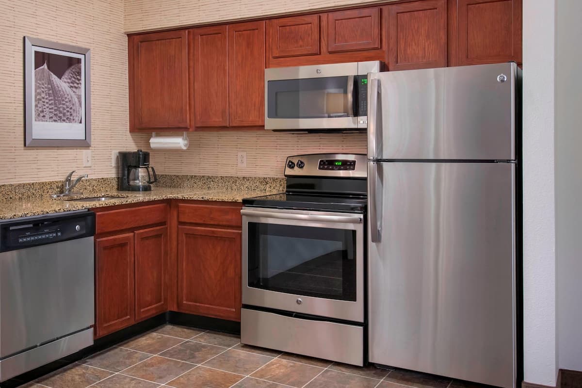 full-sized fridge, microwave, stovetop, coffee/tea maker