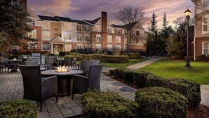 A courtyard with outdoor seating, a fire pit, and a well-maintained lawn. - Residence Inn by Marriott Saddle River (Saddle River)