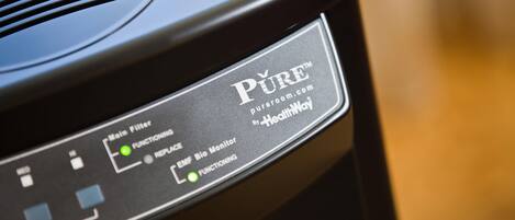 A black electronic device with labels and buttons, including "Main Filter," "EMF Bio Monitor," and "Functioning."