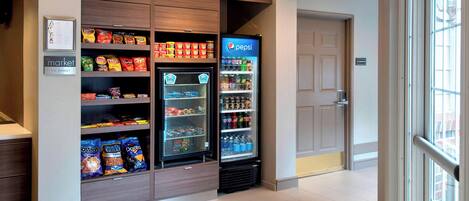 A vending machine area with snacks and beverages, including a Pepsi cooler.