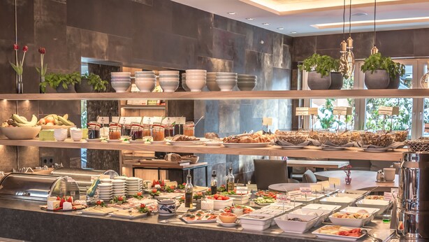 A buffet with various food items and condiments. - Bavaria Boutique Hotel (Munich)