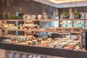 A buffet with various food items and condiments. - Bavaria Boutique Hotel (Munich)