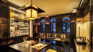 A modern interior with a bar area, seating, and a dining space. - Duxton Reserve Singapore, Autograph Collection (Singapore)