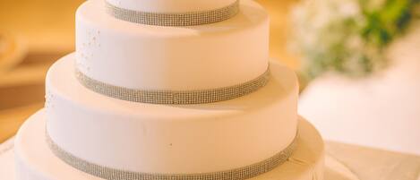 A multi-tiered wedding cake with floral decorations on top.