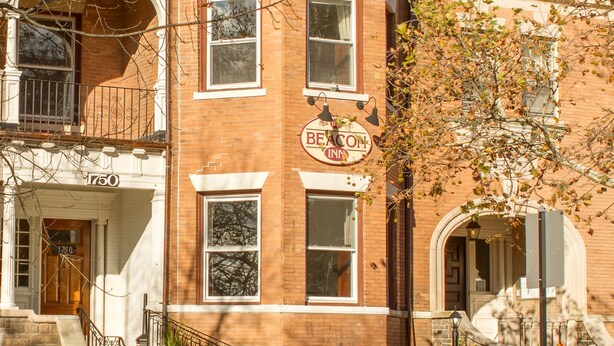 A historic brick building with a prominent 'Breckinridge Inn' sign, a stone staircase, and a large window. - Beacon Inn 1750 (Brookline)