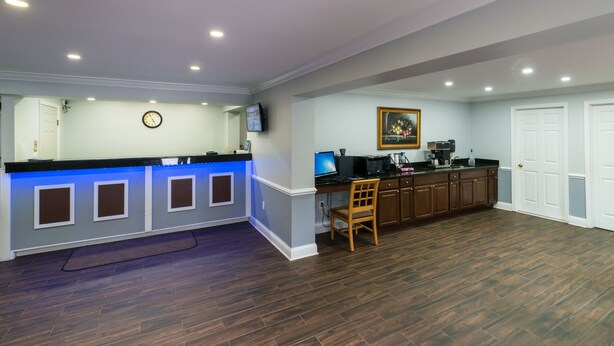 A modern kitchen with a dark wood floor, a blue countertop, and wooden cabinets.