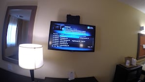 A hotel room with a flat-screen TV mounted on the wall displaying a menu. - Americas Best Value Inn Blythe (Blythe)