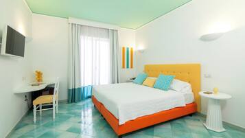 A bedroom with a bed, a desk, and a chair.