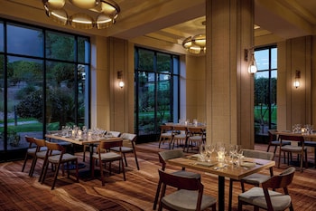 A library with bookshelves, a painting, and seating areas. at The Westin Kierland Resort and Spa