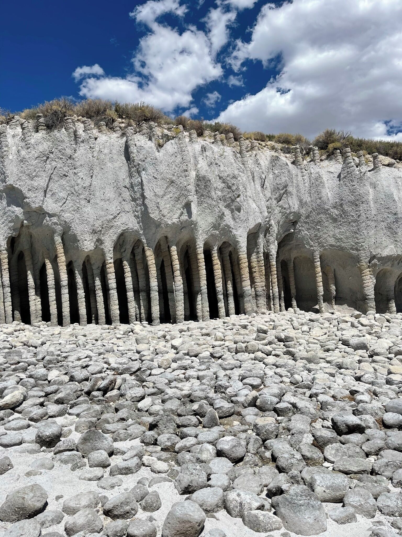 Un paisaje rocoso con una serie de arcos naturales y un cielo despejado.