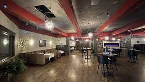 A spacious restaurant with wooden floors, booths, and high ceilings. - Hotel Mead Resorts & Conventions Center (Wisconsin Rapids)