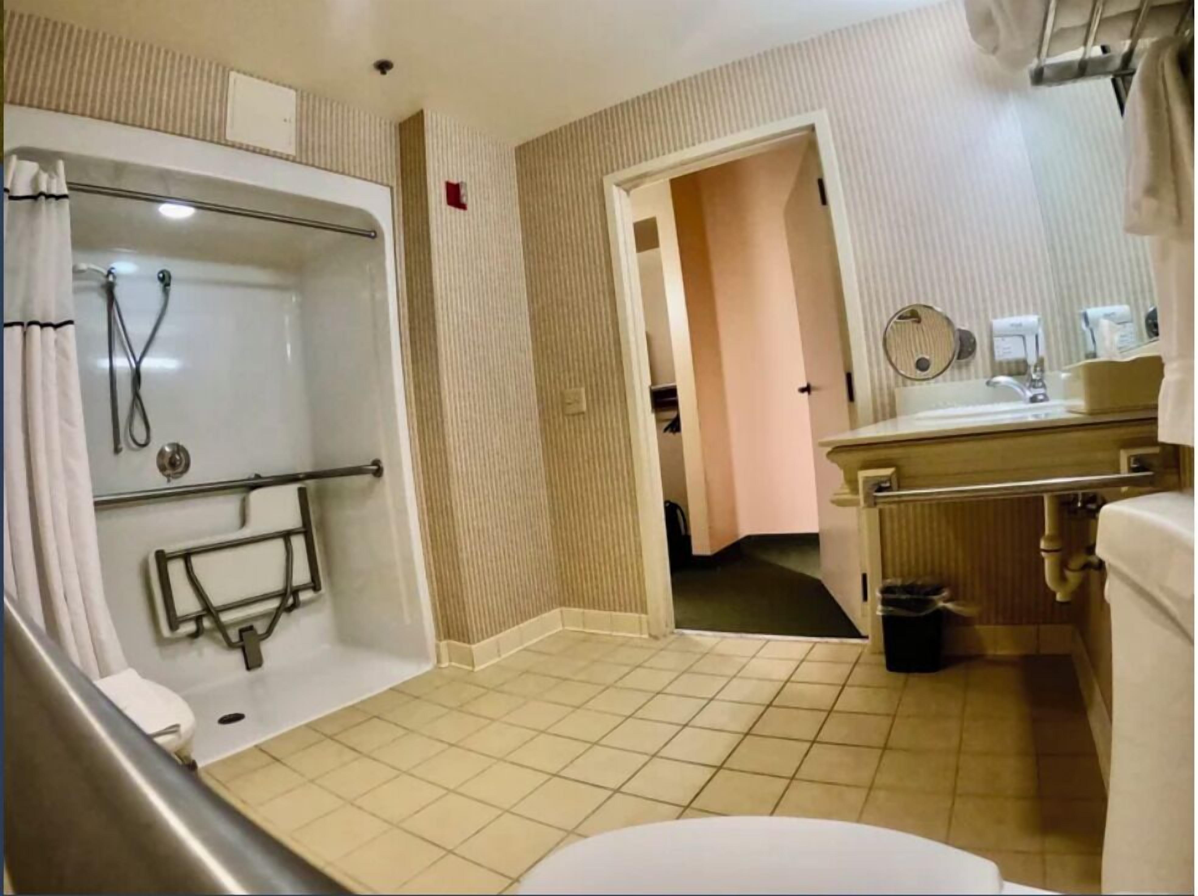 A bathroom with a bathtub, toilet, and sink.