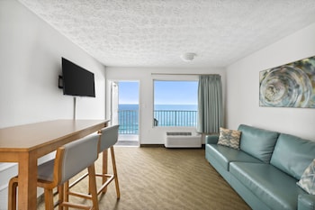 Suite (Ocean/Gulf View) | Living area | 32-inch LCD TV with cable channels, TV at Beachcomber Beachfront Hotel, a By The Sea Resort