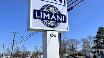 Señal del Falmouth Inn, con el logotipo de Limani Greek Cuisine.