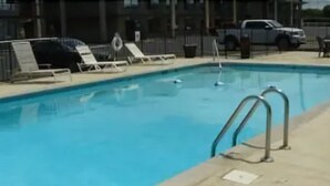 A swimming pool with lounge chairs and a lifebuoy. - Fiddler's Inn (Nashville)