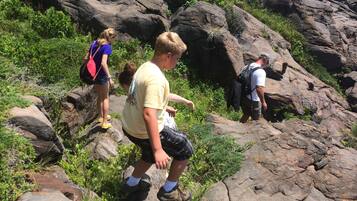 A rocky outdoor area with people hiking.