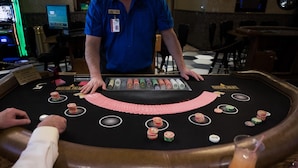 A blackjack table with a dealer and players, a blackjack table with a dealer and players, and a blackjack table with a dealer and players. - Mineral Palace Hotel & Casino (Deadwood)