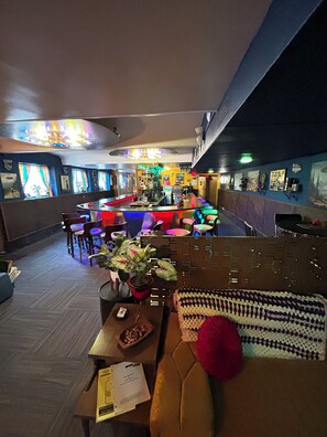 A bar area with a counter, seating, and a decorative ceiling. - O'Haire Inn (Great Falls)
