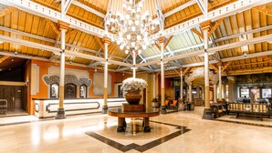 A spacious lobby with a high ceiling, ornate columns, and a central chandelier. - Bali Garden Beach Resort (Kuta)