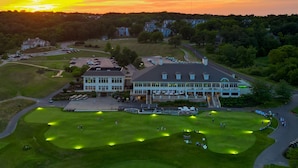 A golf course with a clubhouse and parking area. - Destination Geneva National (Lake Geneva)