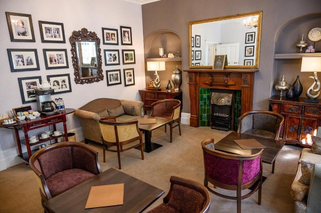 A cozy living room with a fireplace, comfortable seating, and a coffee table.