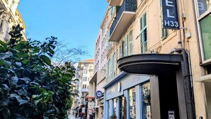 A hotel with a sign reading "HOTEL H33" on a building with balconies and a green awning. - H33 hôtel (Nice)