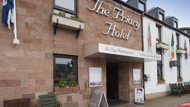 The Priory Hotel with a sign indicating it is an All Day Restaurant and Coffee Lounge & Bars. - The Priory Hotel (Beauly)