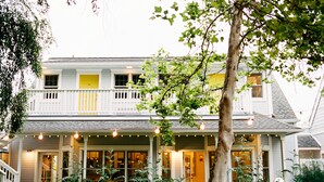 A two-story house with a porch, a staircase, and a garden. - Lithia Springs Resort (Ashland)