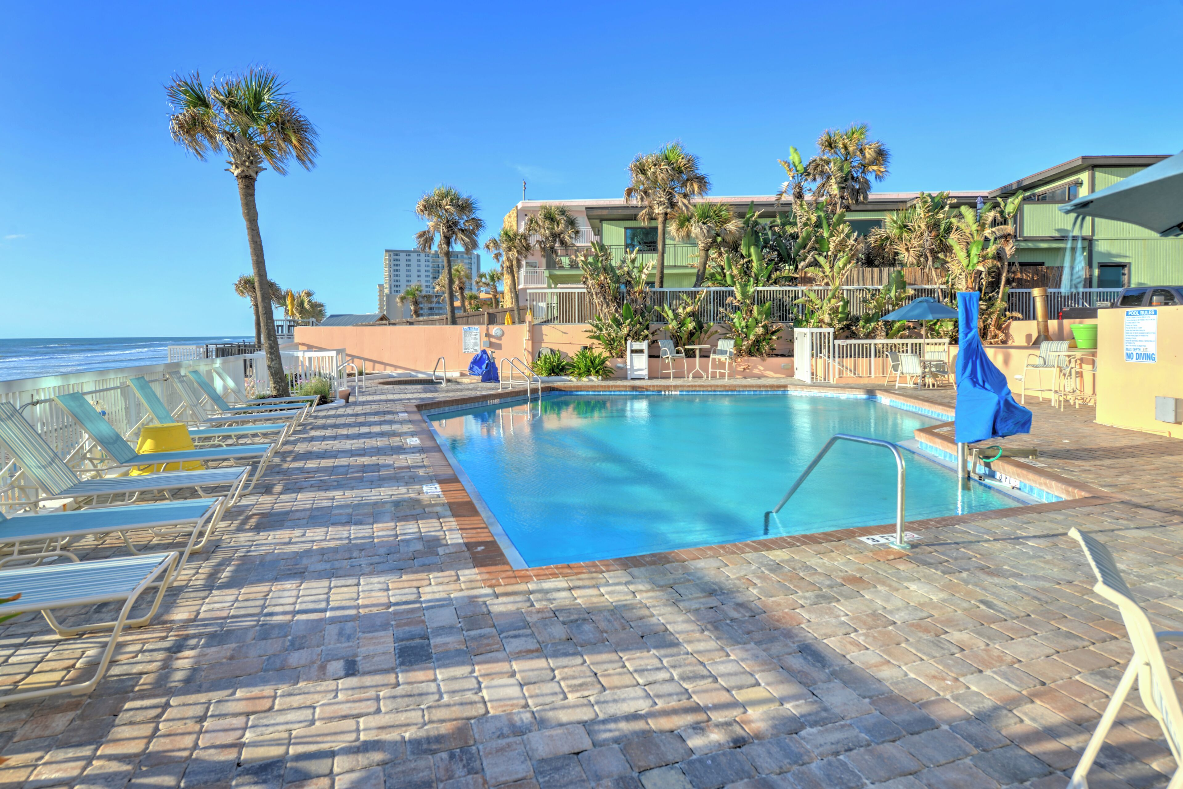 outdoor pool, a heated pool, pool umbrellas, pool loungers