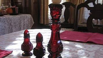 A table with a candle holder and candlesticks.