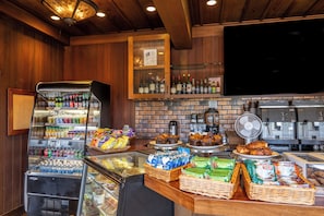 A breakfast bar with a variety of food items, beverages, and a coffee machine.