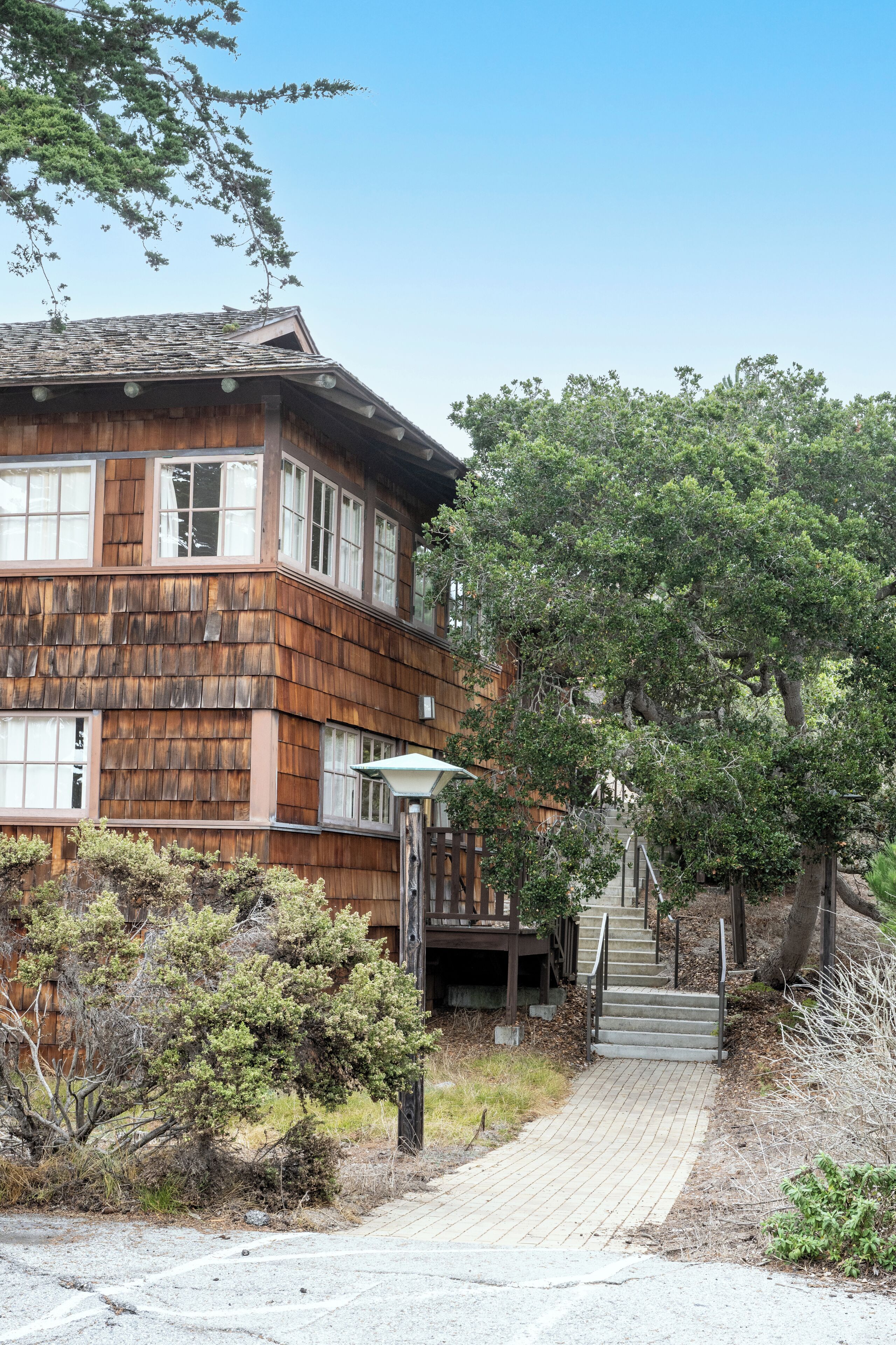 A wooden building with a staircase leading to a deck.