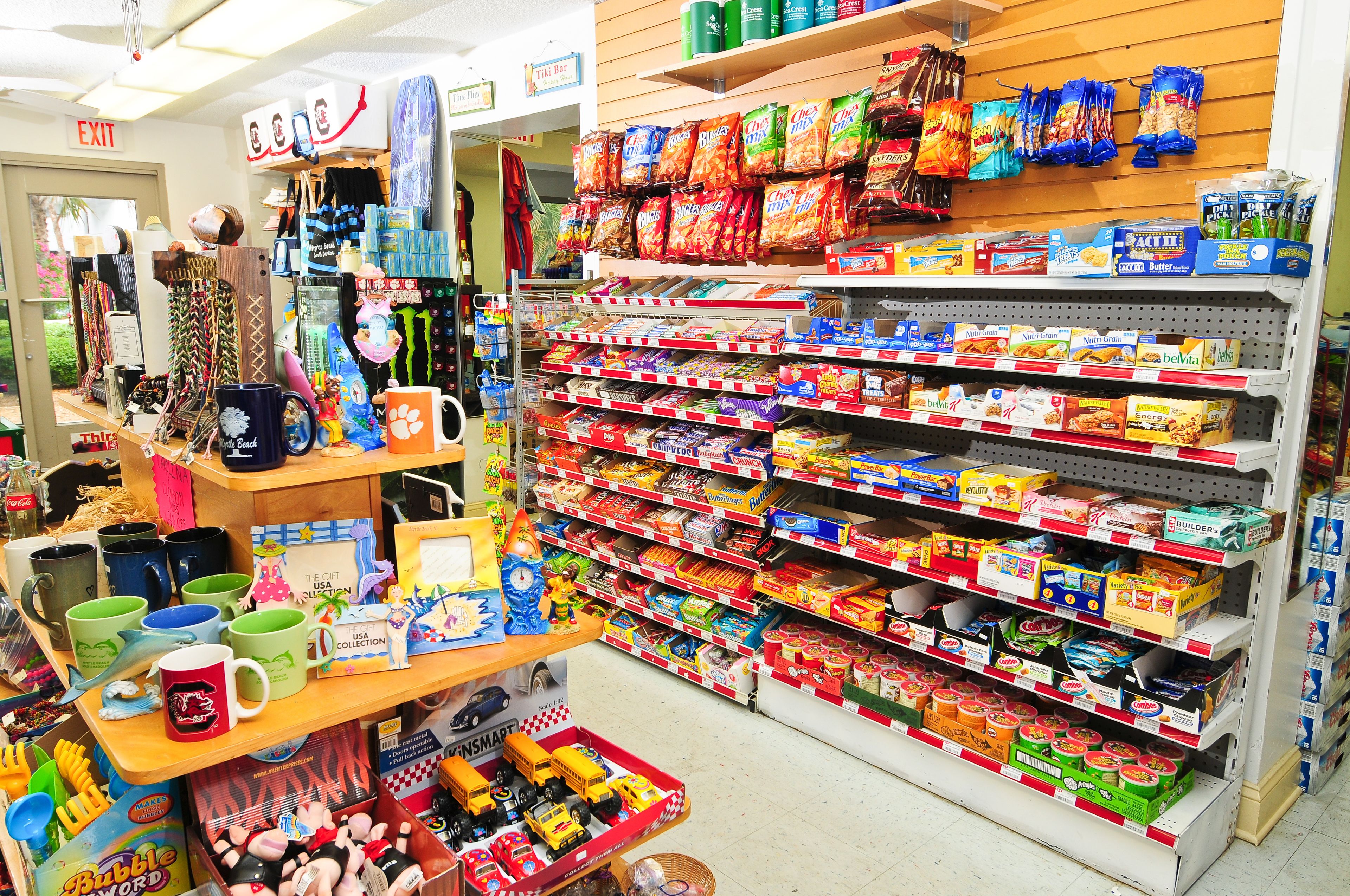 A store with shelves stocked with snacks, toys, and household items.