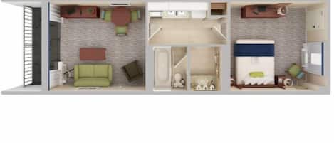 A hotel room with a sofa, a small table, a bed, a bathroom, and a kitchenette.