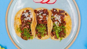 Three tacos on a plate with a blue background. - Motel 6 San Francisco, CA – Great Highway (San Francisco)