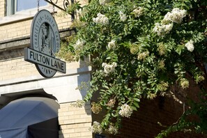 A street sign for Fulton Lane in Charleston, South Carolina, with a brick building in the background. - Fulton Lane Inn (Charleston)