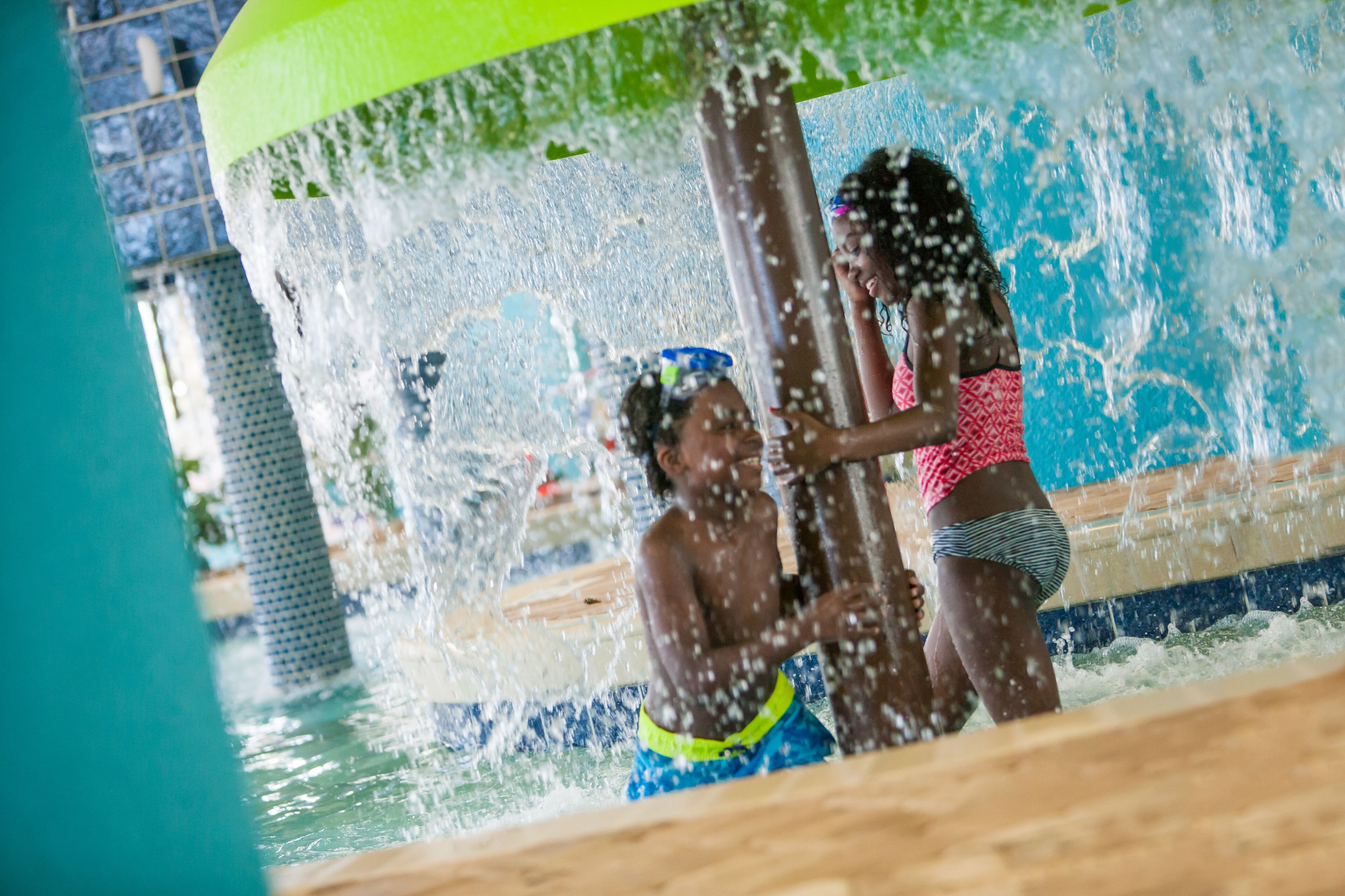 A water play area with a pool and a slide.