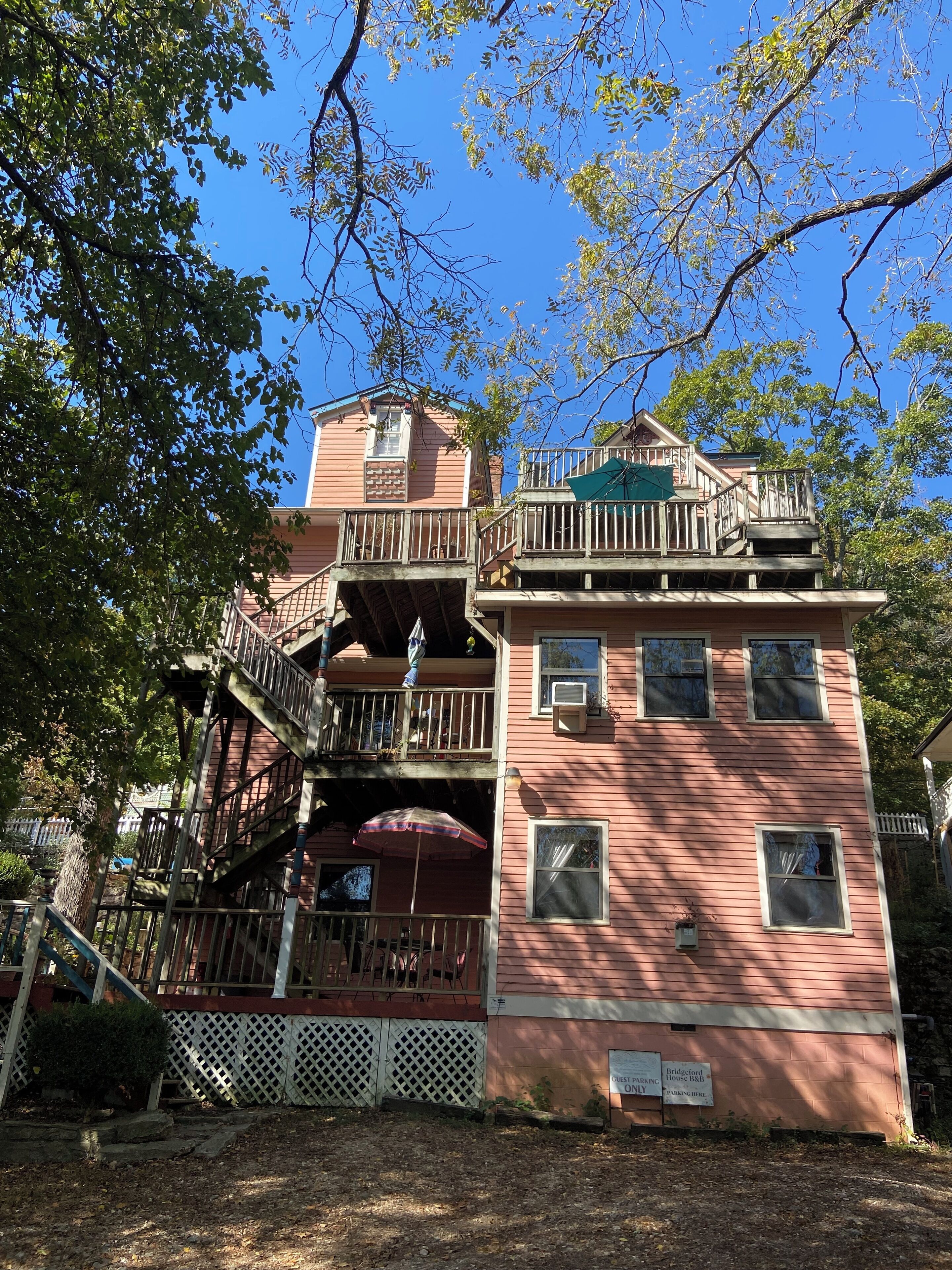 A two-story building with a balcony and a staircase.