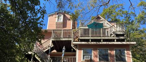 A two-story building with a balcony and a staircase.
